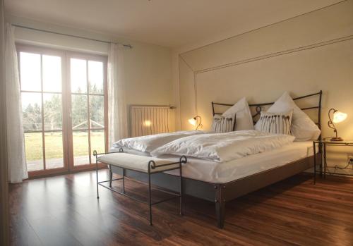 a bedroom with a large bed and a large window at Ferienhaus am Riedl in Siegsdorf