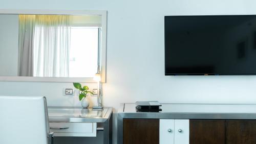 a kitchen with a television and a sink at Dream Hotel Bangkok - SHA Extra Plus Certified in Bangkok