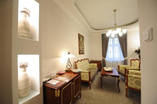 a living room with a table and chairs at Hotel Prince de Ligne in Teplice