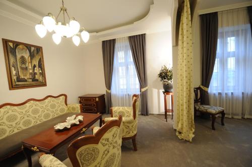 a living room with a couch and a table at Hotel Prince de Ligne in Teplice