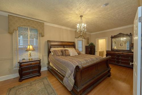 a bedroom with a bed and a dresser and a mirror at The Pillars in Pigeon Forge