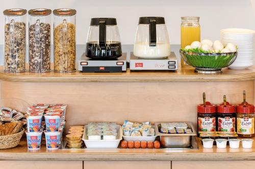 a shelf with various food items on it at CREO Hotel Dessau in Dessau