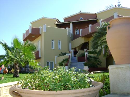 a large pot in front of a house at Heaven Apartments in Agia Marina Nea Kydonias