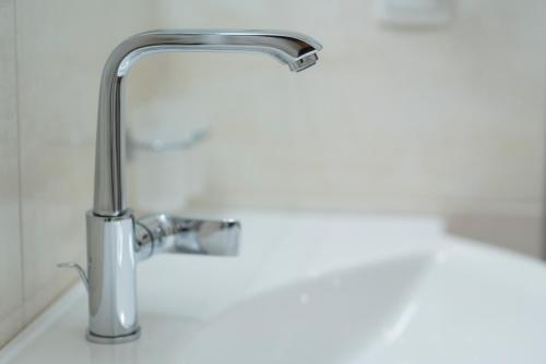 a bathroom sink with a chrome faucet at Bergsporthotel Antonie in Gries im Sellrain