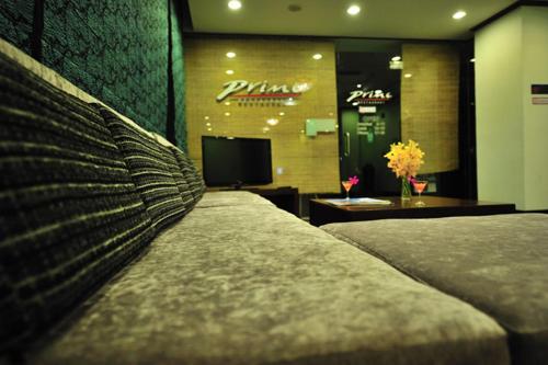 a hotel room with two beds and a television at Thipurai City Hotel in Hua Hin