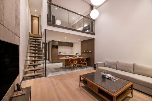 a living room with a couch and a table at Novotel Suites Shanghai Hongqiao in Shanghai
