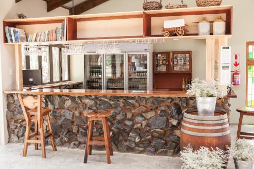 un bar in una stanza con un muro di pietra di The Highveld Cape Inn a Pretoria