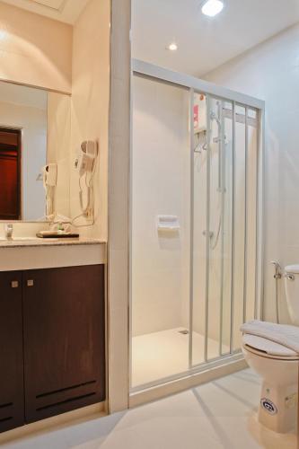 a bathroom with a shower and a toilet at Inn House- SHA Extra Plus in Pattaya