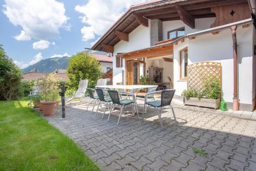 a patio with a table and chairs in a backyard at Chalet Holzerstubn in Ehrwald