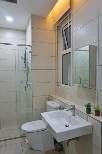 a bathroom with a sink and a toilet and a mirror at PM Octagon Ipoh Suites & Apartment 1 in Ipoh