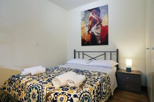 Schlafzimmer mit einem Bett mit Wandgemälde in der Unterkunft Alexandros Apartment in Athen