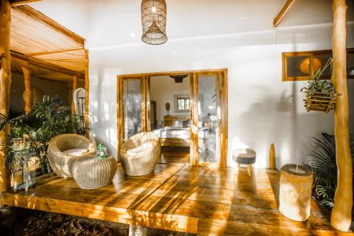 a living room with furniture and a wooden floor at Maligaya Beach Bungalows in El Nido