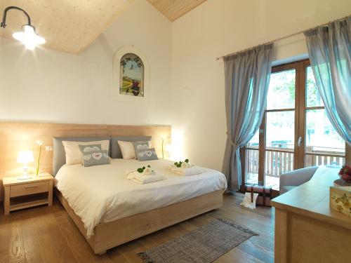 ein Schlafzimmer mit einem Bett und einem großen Fenster in der Unterkunft Chalet Galli in Abbadia San Salvatore