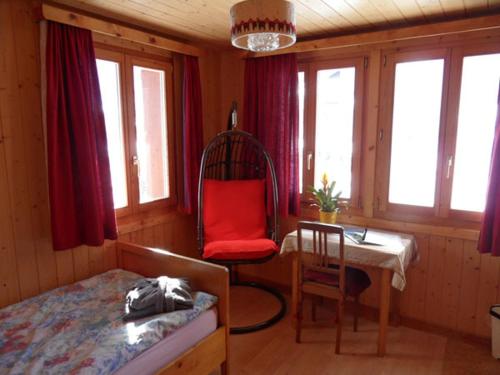 a bedroom with a bed and a chair and a desk at Hotel Restaurant Emshorn in Oberems