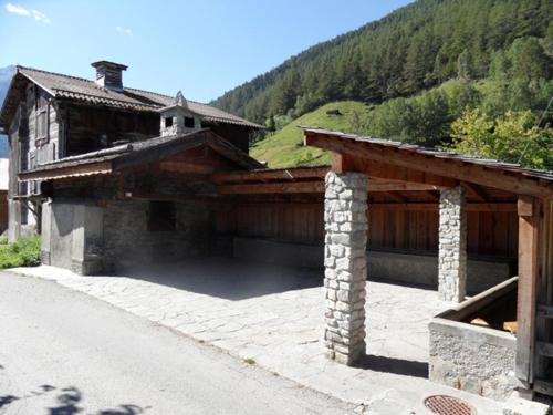 a house with a stone foundation and a roof at Hotel Restaurant Emshorn in Oberems
