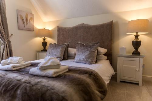 a bedroom with a bed with towels on it at Cricket Field House in Salisbury