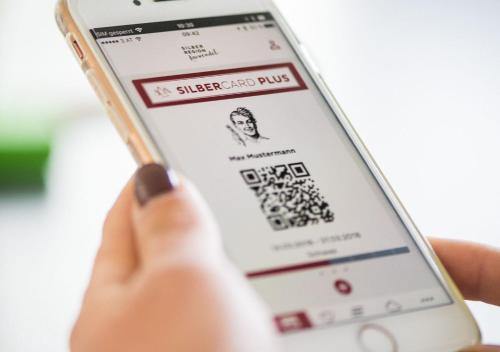 a person holding a sucker lead app on a cell phone at Ferienpension Steiner in Weerberg