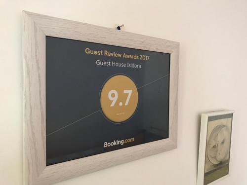 a picture of a clock in a frame on a wall at Guest House Isidora in Arilje