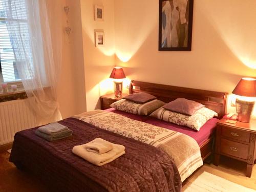 a bedroom with a bed with two towels on it at Patio Mare Amber in Sopot