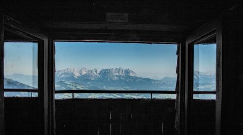 a view of a mountain from a window at Hocheckhuette On Top of the Kitzbuehel Hahnenkamm Mountain in Kitzbühel