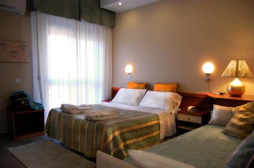 a hotel room with a bed and a couch at Hotel Nordic in Bellaria-Igea Marina
