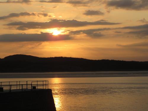 a sunset over a body of water at The Bay Horse Hotel And Restaurant in Ulverston