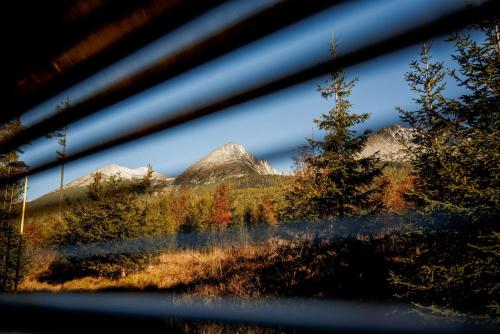 a view of a mountain range from a window at Apartments Pod Kotlom in Vysoké Tatry