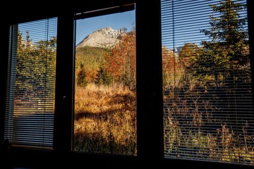 a view of a mountain from a window at Apartments Pod Kotlom in Vysoké Tatry