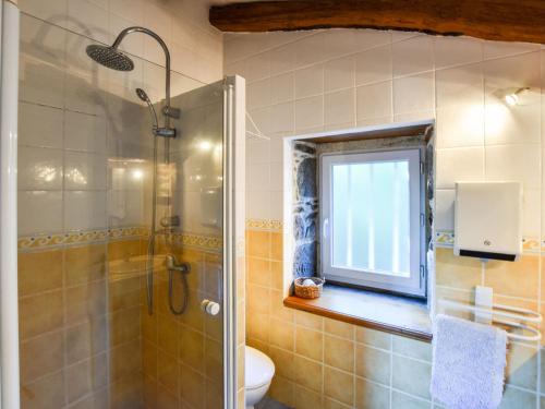 a bathroom with a shower and a window at Holiday Home Saint-Beauzire near Pauillac Castle in Saint-Beauzire
