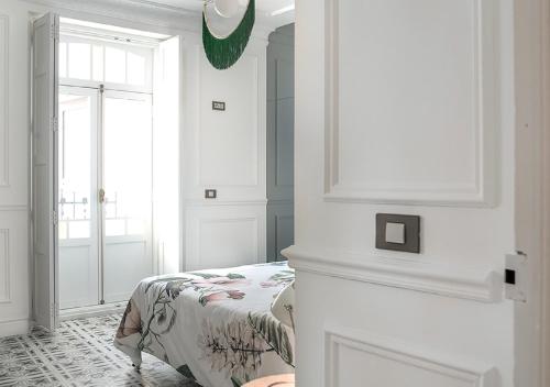 a white bedroom with a bed and a window at Casa Timoteo Apartamentos Boutique Adults Only in Alcoy