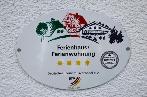 a plate with a picture of a house at Ferienhaus Martina in Bad Brambach