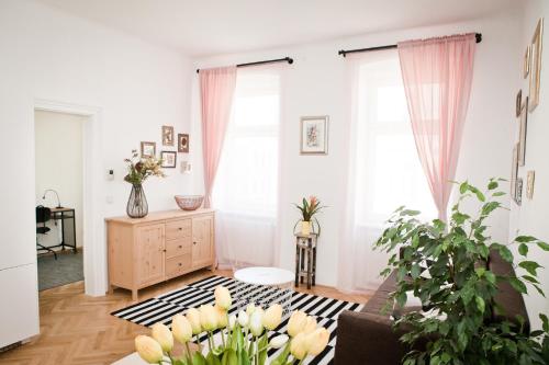 a living room with a couch and two windows at Twin Apartment in Vienna