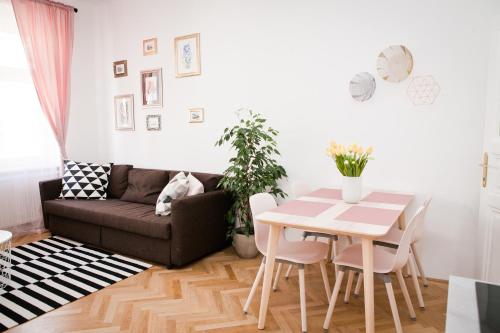 a living room with a table and a couch at Twin Apartment in Vienna