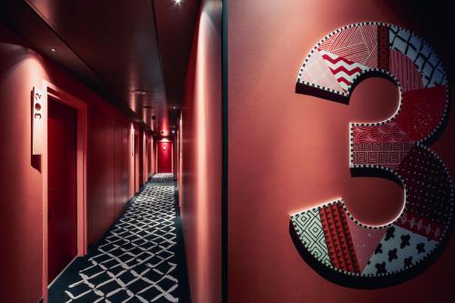 a letter s on the side of a building with a hallway at BOMA easy living hotel in Strasbourg