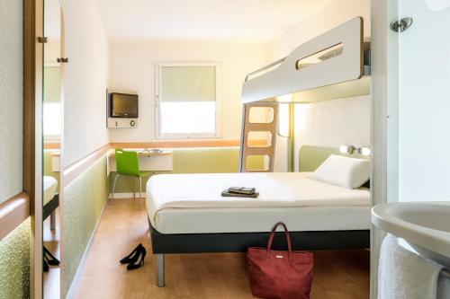 a hotel room with a bed and a sink at ibis budget Duesseldorf Willich in Willich