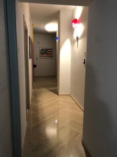 a hallway with a light on the wall and a hallway with a hallway at Napoli City Inn in Naples