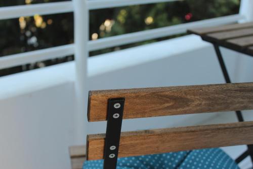 a close up of a wooden bench in front of a window at Olosuites in Limassol