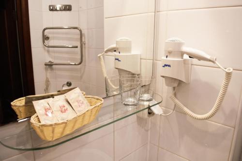 a glass counter in a bathroom with a phone at Vernisage on Ushinskogo in Saint Petersburg