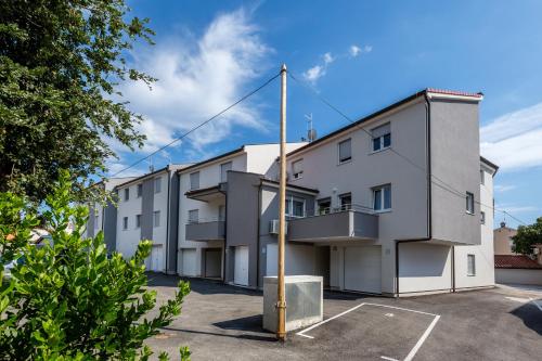 an apartment building with a parking lot at Lux Apartment Medulin Istria in Medulin