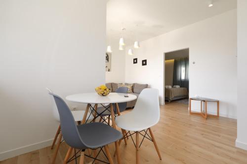 a dining room with a white table and chairs at Vile Dalmacija in Preko