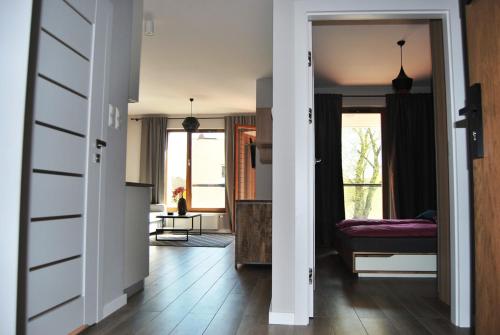 a hallway with a living room with a couch at Ambar Apartament in Gdańsk