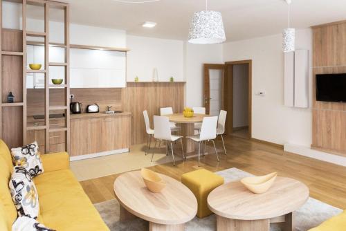 a kitchen and living room with a table and chairs at Turistic Apartments Centar Sarajevo in Sarajevo