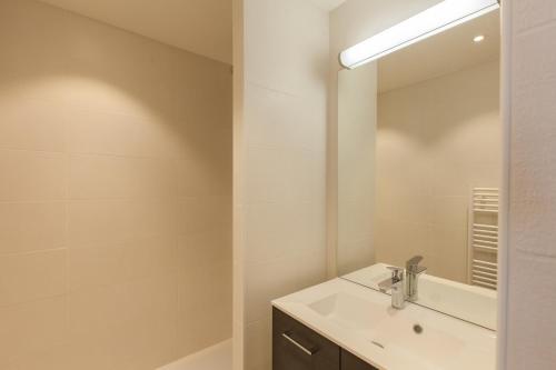 a bathroom with a sink and a mirror at Relais de la Guisane in Briançon