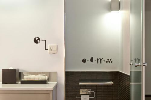 a bathroom with a sink and a shower at amba Taipei Ximending in Taipei