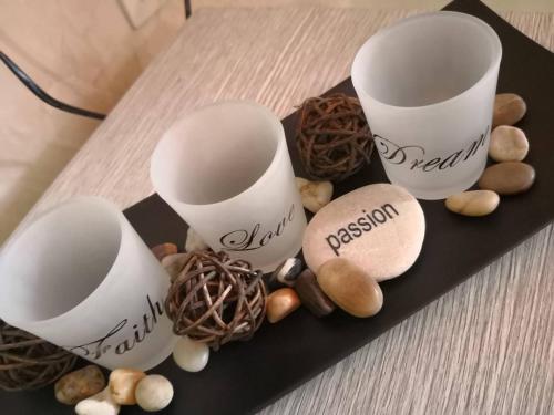 a black plate with three cups and some nuts at Yurukovata kashta in Koprivshtitsa