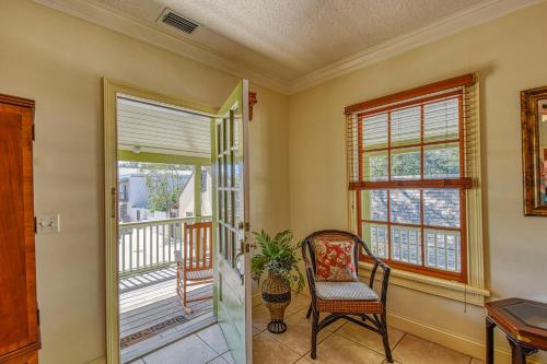 a living room with a chair and a balcony at St George Inn - Saint Augustine in Saint Augustine