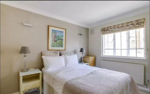 a bedroom with a white bed and a window at Double room in Marylebone in London