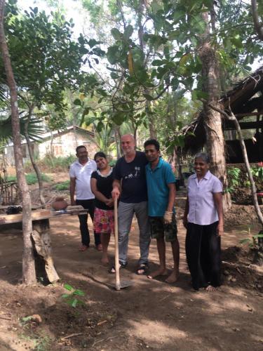 a group of people posing for a picture with a bat at Yapahuwa Relax Stay in Yapahuwa