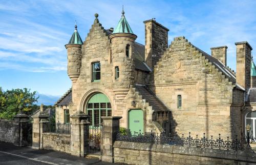 an old stone building with a green door at The Five Turrets in Selkirk