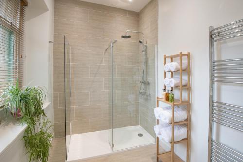 a bathroom with a shower with a glass door at The Five Turrets in Selkirk